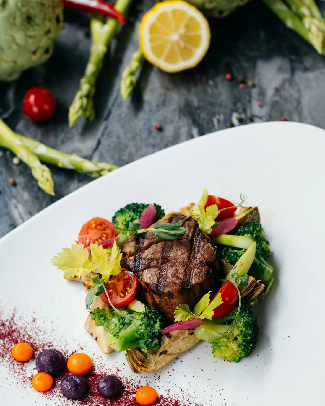 Finely plated fillet of beef with seasonal vegetables